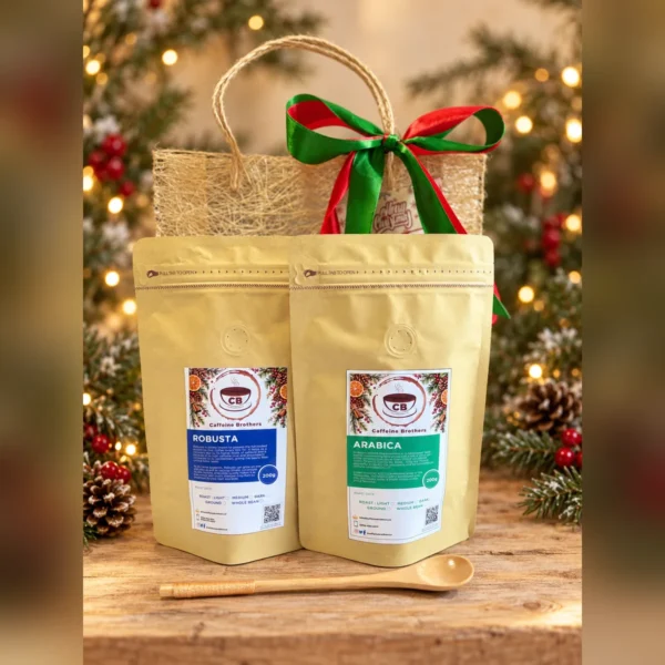 Robusta and Arabica coffee pouches with a wooden spoon and an abaca gift bag on a Christmas table