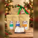Arabica, Robusta and Kapeng Barako coffee pouches with the Coffee Discovery Trio tasting guide and an abaca gift bag on a Christmas table