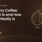 Featured image: Peaberry Coffee, showing a coffee cherry with two flat beans next to a cherry with one round peaberry
